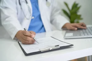 Healthcare professional writing an urgent care doctor's note