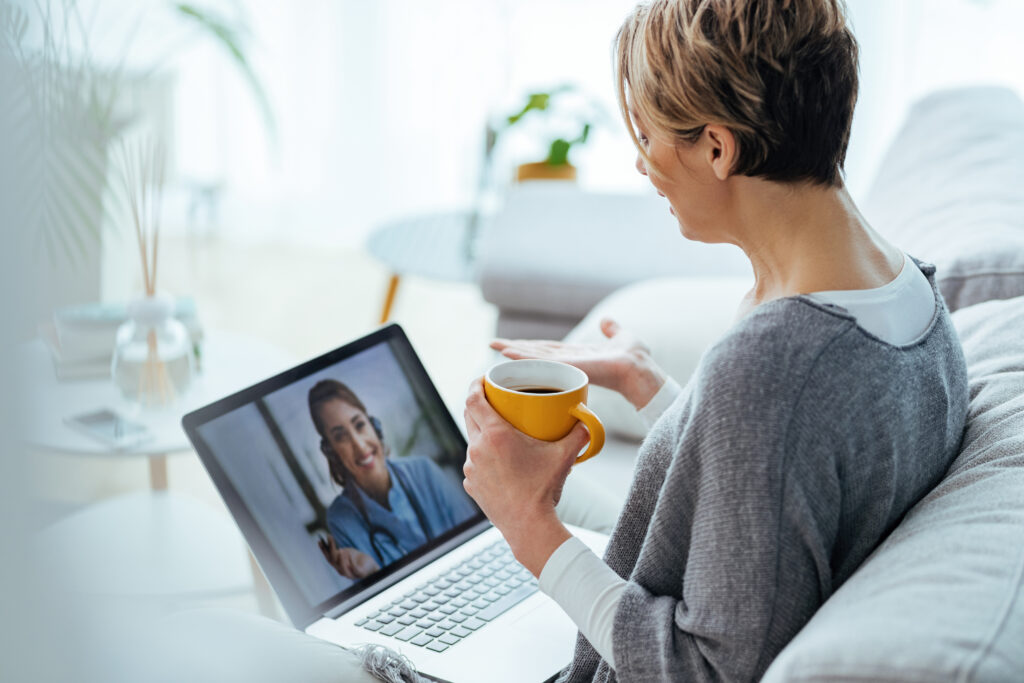 Woman using a laptop to receive therapy from an online therapist
