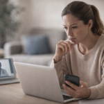 Adult reviewing health information on a laptop at home while considering urgent care options in Toronto.